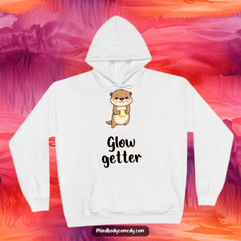 Funny hoodie depicting a joyful otter mid-leap, balancing a luminous orb on its nose with impressive dexterity.